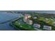 Stunning aerial view of a luxury condo community with a marina, golf course, and ocean views at 3060 Grand Bay Blvd # 182, Longboat Key, FL 34228