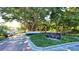 Entrance to Bay Isles Beach Club with lush landscaping and stone signage at 3060 Grand Bay Blvd # 182, Longboat Key, FL 34228