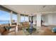 Bright living room with comfortable seating, floor-to-ceiling windows, and picturesque ocean views at 3060 Grand Bay Blvd # 182, Longboat Key, FL 34228