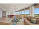 Bright living room with comfortable seating, floor-to-ceiling windows, and views of the golf course at 3060 Grand Bay Blvd # 182, Longboat Key, FL 34228
