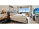 Comfortable bedroom featuring water views and a flatscreen television at 3060 Grand Bay Blvd # 182, Longboat Key, FL 34228