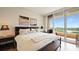Cozy main bedroom with access to a private balcony and a beautiful view at 3060 Grand Bay Blvd # 182, Longboat Key, FL 34228