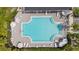 Aerial view of the geometric pool, with lounge seating, tables and umbrellas, surrounded by manicured landscaping at 3108 Rock Sound St, Bradenton, FL 34208