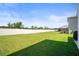 Expansive backyard featuring lush green grass and a privacy fence, perfect for outdoor activities and entertaining at 3108 Rock Sound St, Bradenton, FL 34208