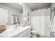 Bathroom features a shower and bath combo and single sink vanity with marble countertop at 3108 Rock Sound St, Bradenton, FL 34208