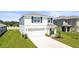 Attractive two-story home featuring a clean white exterior, a two-car garage, and freshly cut lawn at 3108 Rock Sound St, Bradenton, FL 34208