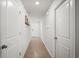 Hallway features neutral colored tile floor and white walls and doors at 3108 Rock Sound St, Bradenton, FL 34208