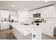 Bright kitchen features stainless steel appliances, a central island, and white cabinetry at 3108 Rock Sound St, Bradenton, FL 34208