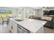 Contemporary kitchen featuring a sink-in island, stainless steel appliances, and eat-in breakfast area at 3108 Rock Sound St, Bradenton, FL 34208