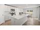Modern kitchen with white cabinets, stainless steel appliances, and a central island at 3108 Rock Sound St, Bradenton, FL 34208