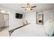 Bright main bedroom features ceiling fan, TV, and ensuite bathroom access at 3108 Rock Sound St, Bradenton, FL 34208