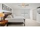 Bright main bedroom with plush carpet, ceiling fan, and ensuite bathroom access at 3108 Rock Sound St, Bradenton, FL 34208