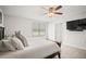 Comfortable bedroom with a ceiling fan, large windows, and a wall-mounted TV at 3108 Rock Sound St, Bradenton, FL 34208