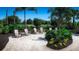 Outdoor seating area features Adirondack chairs, beautiful landscaping, and ample room to relax at 3210 Bitterroot Ln, Lakewood Ranch, FL 34211