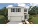 Charming two-story home with a two-car garage, stylish shutters, and a well-manicured lawn at 3210 Bitterroot Ln, Lakewood Ranch, FL 34211