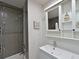 Bathroom featuring a shower-tub combo, tiled walls, and vanity with storage at 3212 Avenue A W, Bradenton, FL 34205