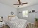 Cozy bedroom with a floral-patterned bed, wood floors, and natural light at 3212 Avenue A W, Bradenton, FL 34205