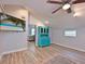 Bonus room with wood-look floors, TV with a beach view, and a turquoise cabinet at 3212 Avenue A W, Bradenton, FL 34205