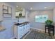 Dining area with wood-look flooring, white hutch and window view to the kitchen at 3212 Avenue A W, Bradenton, FL 34205