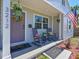 Charming front porch with rocking chairs, welcome mat, and decorative plants creates a warm, inviting entrance at 3212 Avenue A W, Bradenton, FL 34205