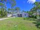 Charming home with a well-maintained lawn, front porch, and mature trees at 3212 Avenue A W, Bradenton, FL 34205