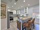 Modern kitchen featuring white cabinets, stainless steel appliances, and a breakfast bar with seating at 3212 Avenue A W, Bradenton, FL 34205