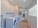 Bright laundry room with a front-load washer and dryer and wood-look floors at 3212 Avenue A W, Bradenton, FL 34205