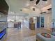 Open-concept living room featuring a modern fireplace, hardwood floors, and access to the kitchen at 3212 Avenue A W, Bradenton, FL 34205