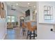 Bright living room and kitchen with counter seating, and wood-look floors at 3212 Avenue A W, Bradenton, FL 34205