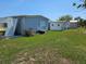 Exterior view of multiple mobile homes, each with unique features and well-maintained surroundings at 3212 Oakwood S Blvd, Sarasota, FL 34237