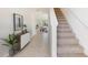 Inviting entryway with a staircase, tile flooring, and decor that offers a glimpse into the dining area at 3214 Bitterroot Ln, Lakewood Ranch, FL 34211