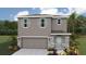 Charming two-story home showcasing a landscaped yard, two-car garage, and stylish shutter accents at 3214 Bitterroot Ln, Lakewood Ranch, FL 34211
