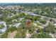 An aerial view showcasing the property nestled among lush trees in a residential neighborhood with nearby waterways at 3934 Brookside Dr, Sarasota, FL 34231