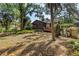 Cozy home backyard featuring a screened porch, wooden deck, mature trees, and lush foliage at 3934 Brookside Dr, Sarasota, FL 34231