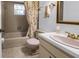 Traditional bathroom features a tub with tile surround and a floral shower curtain at 3934 Brookside Dr, Sarasota, FL 34231