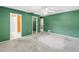 A bedroom with a green wall, fan and entrances to other rooms and closets at 3934 Brookside Dr, Sarasota, FL 34231