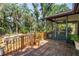 Wooden deck offers access to the screened-in porch and views of the backyard at 3934 Brookside Dr, Sarasota, FL 34231