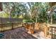 Wooden deck is surrounded by a wood fence and lush greenery at 3934 Brookside Dr, Sarasota, FL 34231