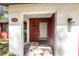 Close-up of the front entrance with a decorative door and stone-paved porch at 3934 Brookside Dr, Sarasota, FL 34231