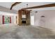 Bright living room featuring beamed ceilings, a stone fireplace, and an open layout at 3934 Brookside Dr, Sarasota, FL 34231