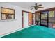 Screened-in porch features a ceiling fan and sliding door access to the interior at 3934 Brookside Dr, Sarasota, FL 34231