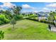 Community dog park featuring lush grass, mature trees, and secure fencing for your furry friends at 4411 Dusky Dawn Ln, Palmetto, FL 34221