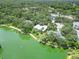 Breathtaking aerial view of home near a lake, enhanced by mature trees and beautiful natural surroundings at 4443 Robin Hood W Trl, Sarasota, FL 34232