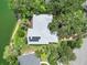 Overhead aerial of home with solar panels and spacious layout, surrounded by greenery and landscaping at 4443 Robin Hood W Trl, Sarasota, FL 34232