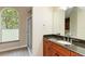 Bathroom featuring granite countertop vanity and shower with clear glass doors at 4443 Robin Hood W Trl, Sarasota, FL 34232
