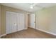 Bedroom featuring closet, fan, light wood-look floors, and view of other rooms at 4443 Robin Hood W Trl, Sarasota, FL 34232