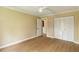 Bedroom featuring closet, fan, light wood-look floors, and view of other rooms at 4443 Robin Hood W Trl, Sarasota, FL 34232
