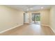 The spacious bedroom has neutral paint, ceiling fan, and sliding door to the lanai at 4443 Robin Hood W Trl, Sarasota, FL 34232