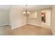 Bright dining area featuring a modern chandelier and wood flooring, adjacent to the kitchen at 4443 Robin Hood W Trl, Sarasota, FL 34232