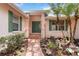 Charming front entrance with manicured landscaping and a brick walkway at 4443 Robin Hood W Trl, Sarasota, FL 34232
